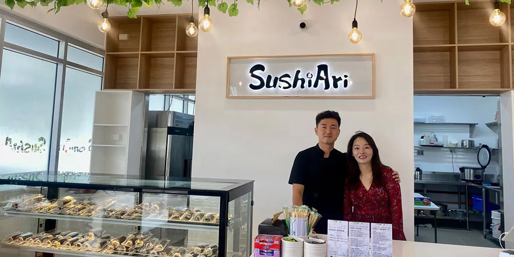 Sungmin from Sushi Ari standing in front of the sushi counter